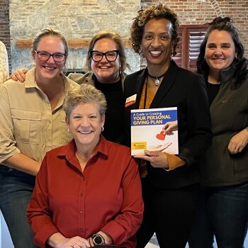 Group with "A Guide to Your Personal Giving Plan" book